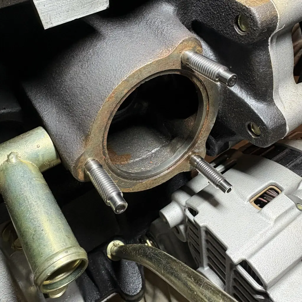 RB26 thermostat housing flange with titanium studs installed